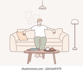 Happy man sitting on comfortable couch at home in living room. Cheerful casual man relaxing on sofa, enjoying weekend free time or break from work. Hand drawn style vector design illustrations.