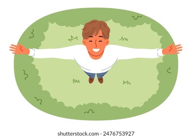 Happy man stands on lawn and looks up enjoying rays of sun and fresh air on summer day. Guy smiles and puts hands to side, feeling freedom and surge of positive emotions due to summer holidays