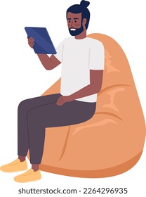 Happy man with tablet sitting on beanbag chair semi flat color vector character. Editable figure. Full body person on white. Simple cartoon style illustration for web graphic design and animation