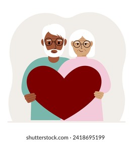 Happy man and woman holding a big red heart in their hands. Love