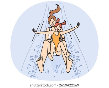 Happy mother and daughter screaming for joy going down water slide in aquapark for children recreation. Girl together with mom are relaxing in pool enjoying joint rest in aquapark