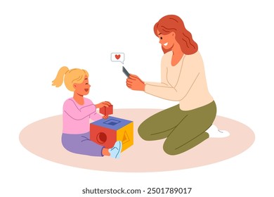 Happy mother takes photo of little daughter playing with blocks on mobile phone camera. Mother rejoices at success of pre-teen child demonstrating talent and readiness for development