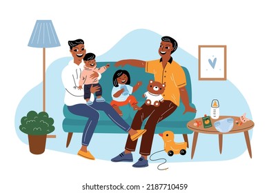 Happy motherhood. Smiling family sitting on sofa in living room. Laughing children and young parents. Home atmosphere. Baby care. Mother and father with toddlers. Garish