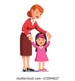 Happy mum walking with little daughter holding her hands. Cute smiling girl in pink dress learning to walk. Caring mother or babysitter woman helping child. Flat vector illustration isolated on white.