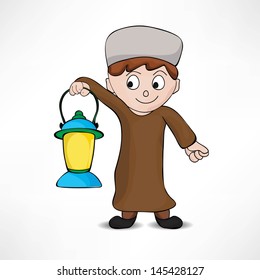 Happy Muslim boy in traditional dress holding illuminated arabic lantern concept for holy month of Ramadan Kareem.