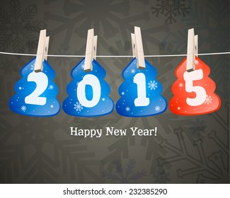 Happy new year 2015 in the form of Christmas trees on clothespins.