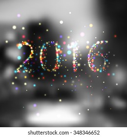 Happy new year 2016 writing sparkles firework with dirty defocused light blur bokeh background