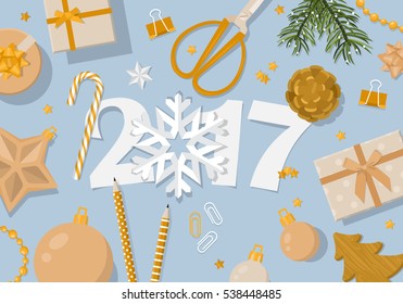 Happy New Year 2017 creative banner design in flat modern style. Paper cut numbers and decorations in gold from flat lay top view.