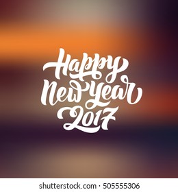 Happy New Year 2017 hand-lettering text on blurred background. Handmade vector calligraphy collection