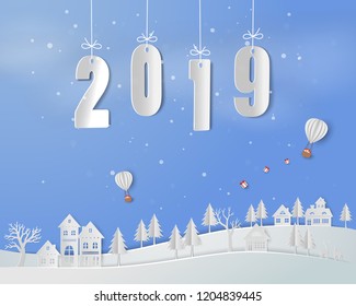 Happy new year 2019 on paper art background,white balloon with gift box floating above countryside house