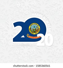 Happy New Year 2020 with flag of US state Idaho on snowflake background. Greeting Idaho with new 2020 year.