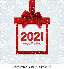 Happy New Year 2021 design, square banner in form of Christmas gift with red ribbon and bow, on winter background with snow. Greeting card, brochure or banner template. Vector illustration.