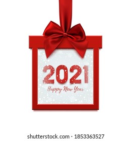 Happy New Year 2021 design, square banner in form of Christmas gift with red ribbon and bow, on winter background with snow and snowflakes. Greeting card, brochure or banner template. Vector illustrat