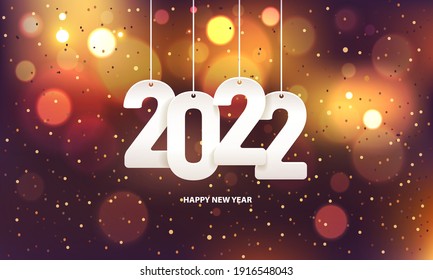 Happy new year 2022. Hanging white paper number with confetti on a colorful blurry background.