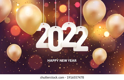 Happy new year 2022. Hanging white paper number with gold balloons and confetti on a colorful blurry background.