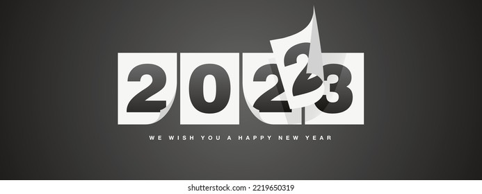 Happy New Year 2023 greeting card design template on black background. New Year 2023 start concept. Calendar pages turn in the wind and the new year begins