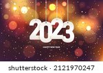 Happy new year 2023. Hanging white paper number with confetti on a colorful blurry background.