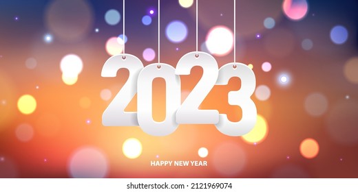 Happy new year 2023. Hanging white paper number on a colorful blurry background.