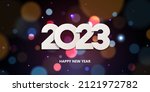 Happy New Year 2023. Holiday greeting card design. White paper numbers on a defocused colorful, bokeh background.