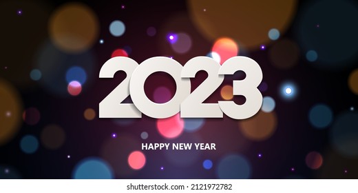 Happy New Year 2023. Holiday greeting card design. White paper numbers on a defocused colorful, bokeh background.