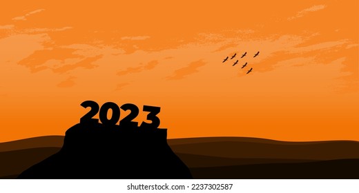 Happy New year 2023 with large silhouette letters on the mountain with a beautiful sunset for success concept. new year concept