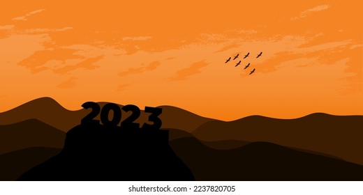 Happy New year 2023 with large silhouette letters on the mountain with a beautiful sunset for success concept. new year concept
