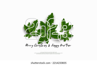 Happy New Year 2023 and merry christmas day. Design number outline on group of green leaves on white background.