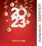Happy new year 2023. White paper numbers with golden Christmas decoration and confetti on  red background. Holiday greeting card design.