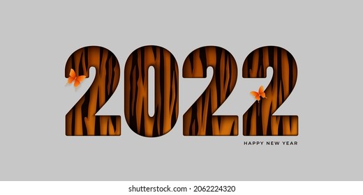 Happy New Year abstract background. Paper cut 2022 numerals  with tiger spots on a light backdrop