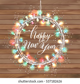 Happy new year design on wooden texture. Wreath of bright light garlands.