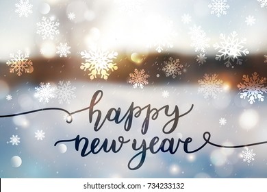 happy new year, lettering on winter blurred background
