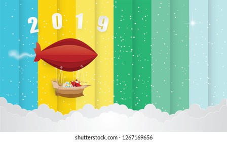 Happy new year and Merry Christmas with Santa Claus in snow on the sky on text 2019 colorful background,Illustration and vector paper art style.