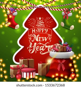 Happy New Year, red and green square greeting card with Christmas tree cut out of paper, Christmas stockings and red Santa Claus bag with presents