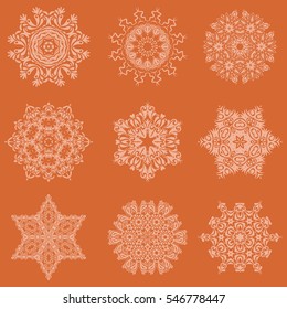 Happy New Year winter background. Vector design for textile, wallpaper, fabric, wrapping paper. Orange background with simple Christmas set - nine varied Xmas snowflakes with dots.