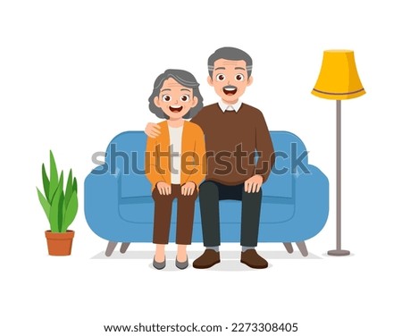 happy old couple sit on sofa and loving together