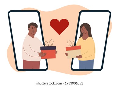 happy people. Give each other gifts. A woman gives a man a gift. The guy gives the girl a present via phone. Holiday surprise. Celebrating Christmas. Charity. Couples giving and holding presents