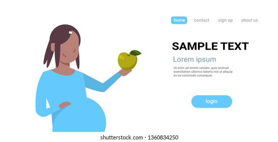 happy pregnant woman holding green apple pregnancy and motherhood concept african american girl eating healthy fresh fruit food flat portrait horizontal copy space