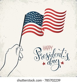 Happy Presidents Day. Woman hand holding USA flag with text on retro background. USA Independence Day banner in vintage style.