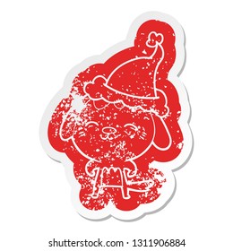 happy quirky cartoon distressed sticker of a dog wearing santa hat