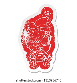 happy quirky cartoon distressed sticker of a girl wearing santa hat