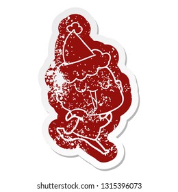 happy quirky cartoon distressed sticker of a bald man wearing santa hat