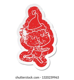 happy quirky cartoon distressed sticker of a bald man wearing santa hat