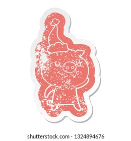 happy quirky cartoon distressed sticker of a pig wearing santa hat