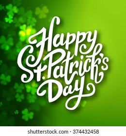 Happy Saint Patrick's day handwritten message, brush pen lettering on blurred green shamrock background postcard, vector illustration