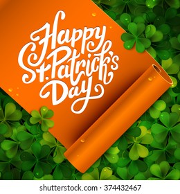 Happy Saint Patrick's day handwritten message, brush pen lettering on orange ribbon and green shamrock background postcard, vector illustration