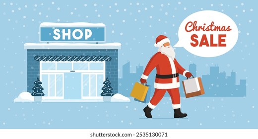 Happy Santa Claus holding bags and doing Christmas shopping, city skyline in the background, holidays and sale concept