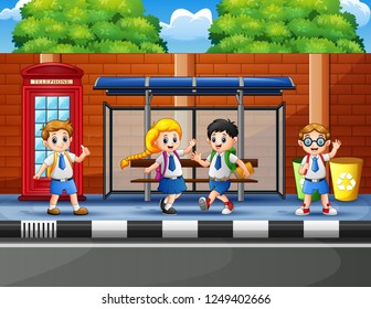 Happy school children at the bus stop