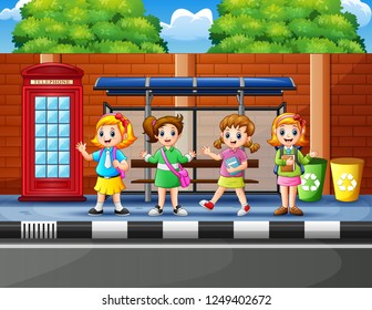 Happy school children at the bus stop