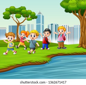 Happy school children playing in the city park
