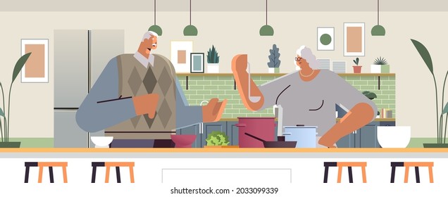 happy senior couple preparing healthy food at home grandparents cooking together old age concept